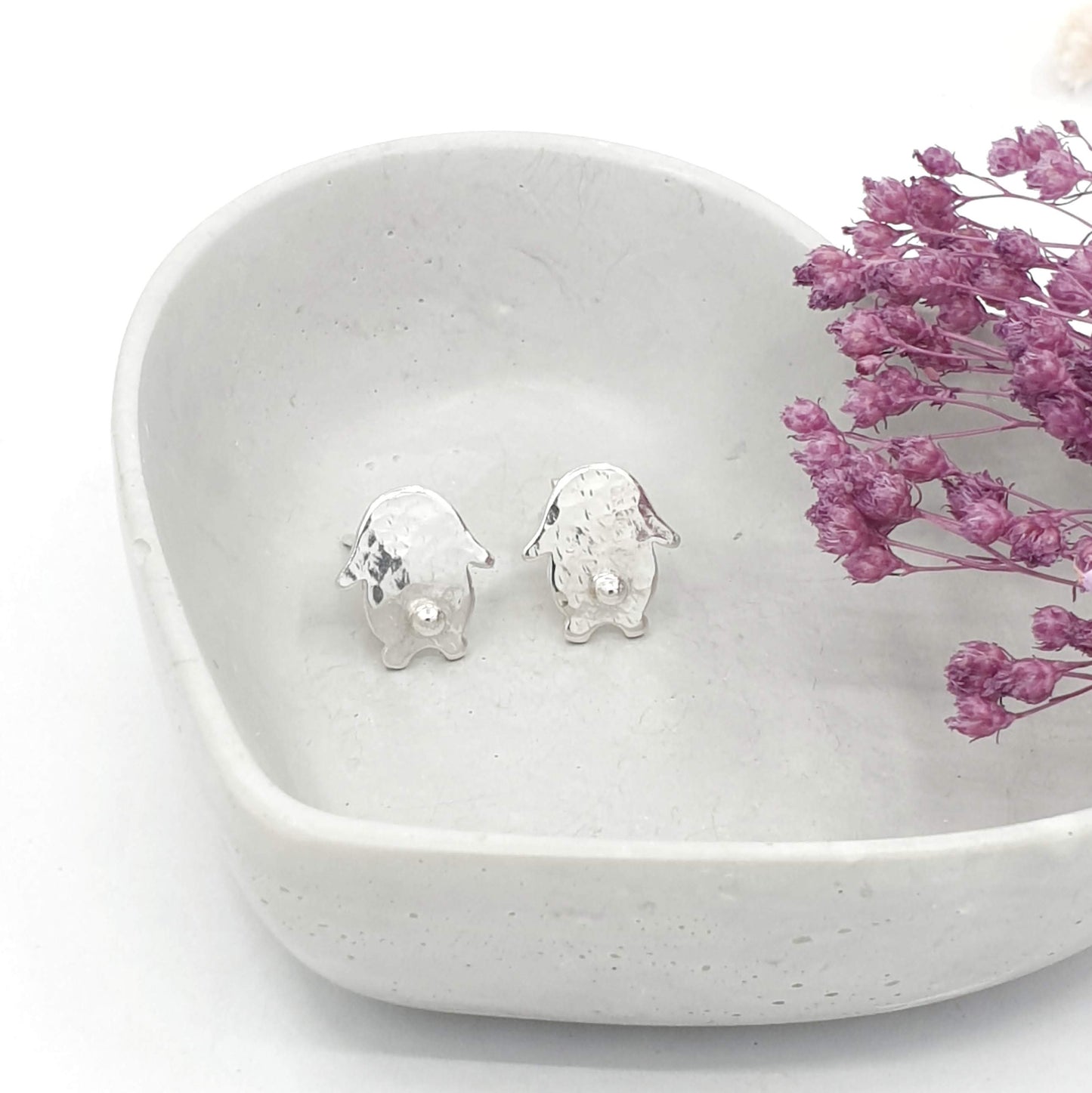 hammmered texture silver earrings of a rabbit with 3d silver tail