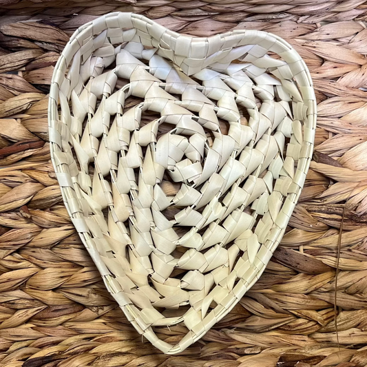 Woven heart shaped basket  on a woven mat background