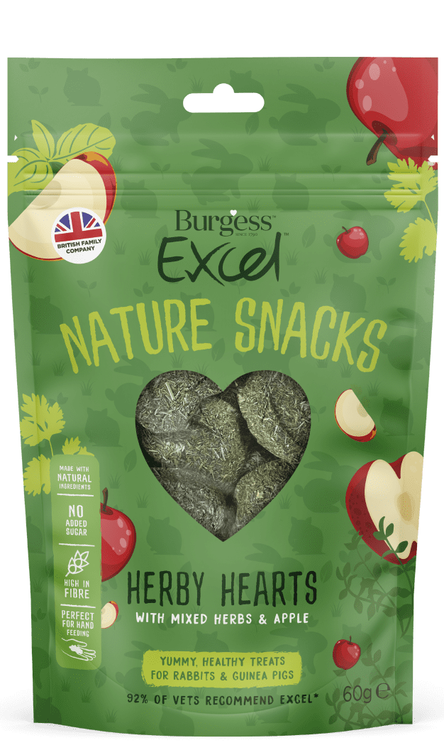 The green packet for the Burgess Excel herby hearts nature snacks is covered in a smattering of cartoon images of red apples and mixed herbs. A cleat heart shaped window shows the heart shaped hay, herb and apple treats within. A highlighted box shows the benefits, natural ingredients, no added sugar, high in fibre and perfect for hand feeding. yummy treats for rabbits and guinea pigs with a 92% vet recommendation.