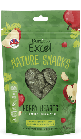 The green packet for the Burgess Excel herby hearts nature snacks is covered in a smattering of cartoon images of red apples and mixed herbs. A cleat heart shaped window shows the heart shaped hay, herb and apple treats within. A highlighted box shows the benefits, natural ingredients, no added sugar, high in fibre and perfect for hand feeding. yummy treats for rabbits and guinea pigs with a 92% vet recommendation.