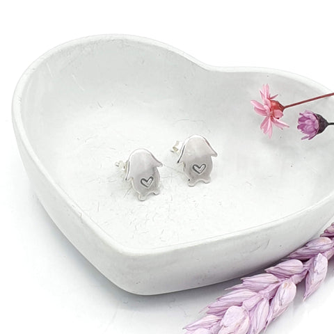 Silver stud earrings in the shape of a lop bunny. A love heart is engraved in the middle of each earring.