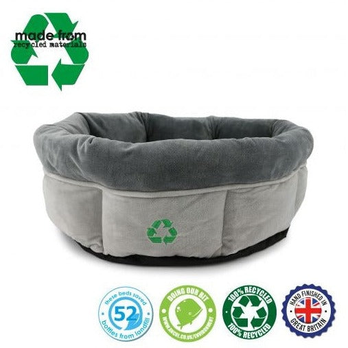 Plush recycled pet bed made with dark grey interior and light grey exterior. With a green recycling symbol on the front.