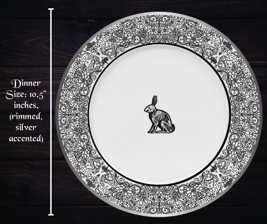 Gothic dinner plate as described previously on a dark wood background with words 'dinner size: 10.5 inches. (rimmed silver accented)'