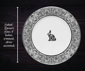 Gothic dinner plate as described previously on a dark wood background with words 'salad/dessert size: 8 inches. (rimmed silver accented)'