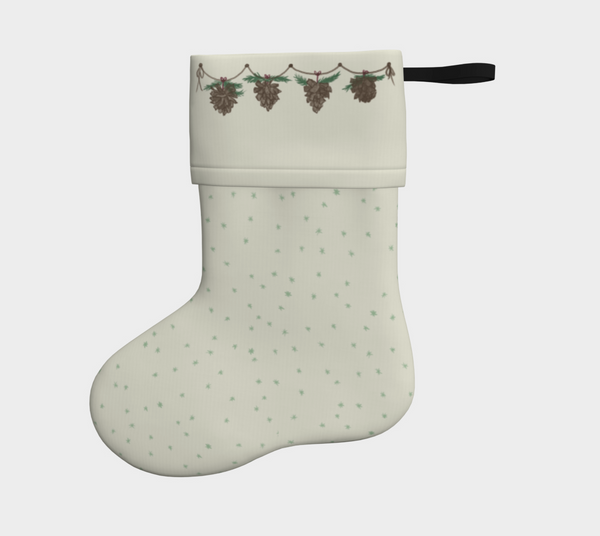 cream Christmas stocking with a delicate snowflake design under a hand drawn garland of pine cones.