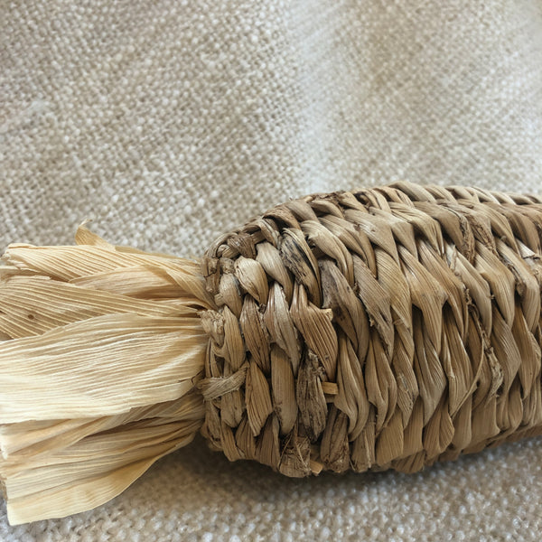 Snazzy close-up of Rosewood banana leaf stuffer carrot-shaped chew toy for rabbits showing natural fibre textures.