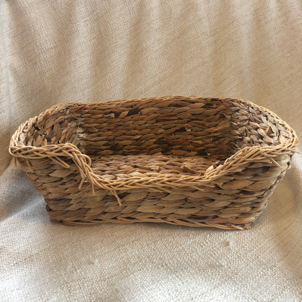 Rosewood chill n snooze bed, an oblong woven basket with dip on one size.