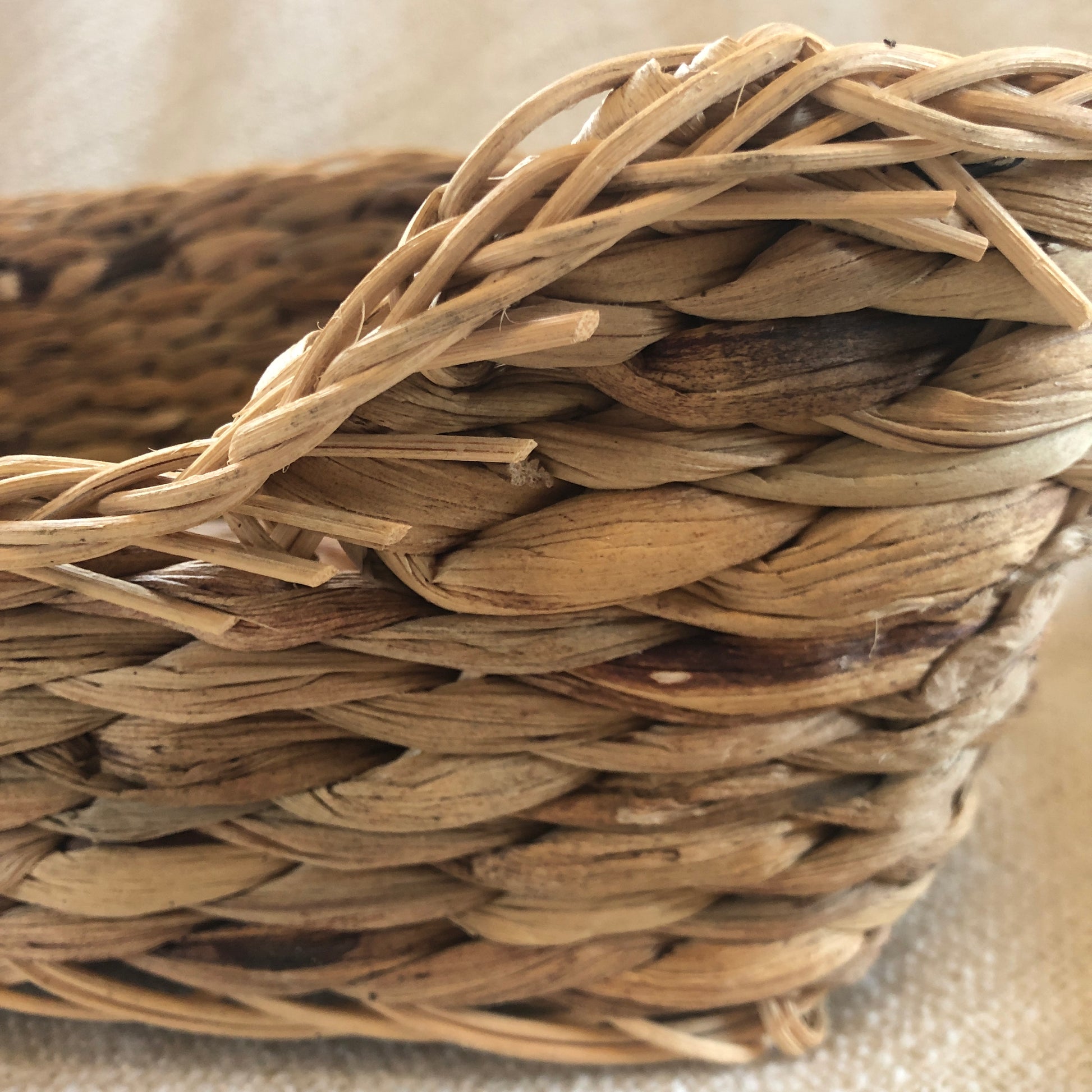 Snazzy close up of Rosewood chill n snooze bed showing texture of the woven water hyacinth over rattan frame.