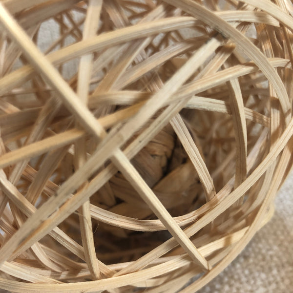 Close up of Rosewood rattan wobble ball showing the water hyacinth ball inside.